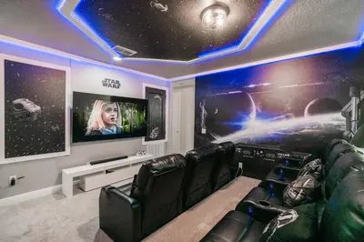 a room with black leather chairs and a flat screen tv at Stunning Luxury 9BR Encore Villa by Disney in Orlando