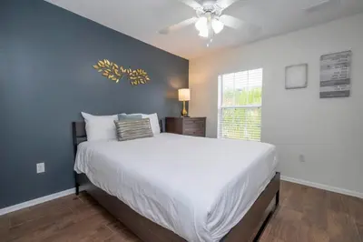 a bedroom with a large bed and a ceiling fan at Marvelous 3Bd w Jacuzzi at Terra Verde Resort 4757 in Kissimmee