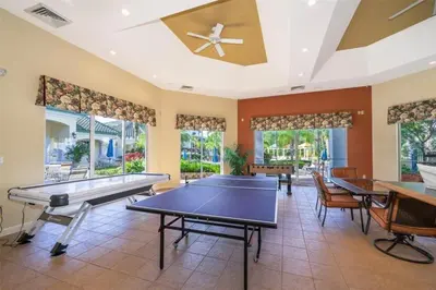 a living room with ping pong tables and chairs at LD8830-12-308DC - Legacy Dunes condo for 8 guests in Kissimmee