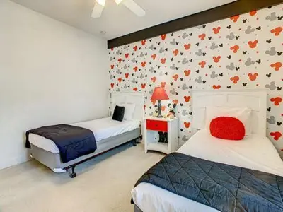 a bedroom with two beds and a wall with flowers at LV2950-105LHC - 4 bedrooms - Lucaya Resort in Kissimmee
