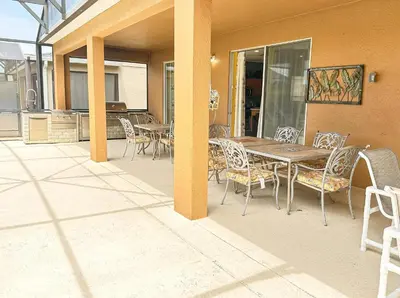 a patio with a wooden table and chairs at EIR8505PH - Emerald's paradise by Disney in Kissimmee