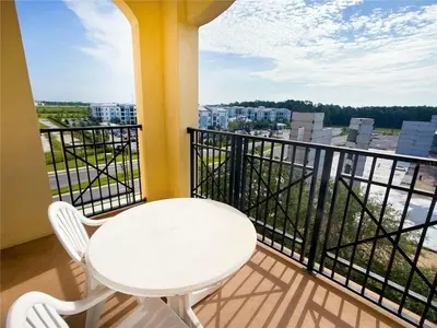 a white table and chairs on a balcony at Best Disney Resort Condo Orlando in Orlando