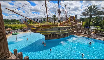 a large pool with a pirate ship in it at Best Disney Resort Condo Orlando in Orlando