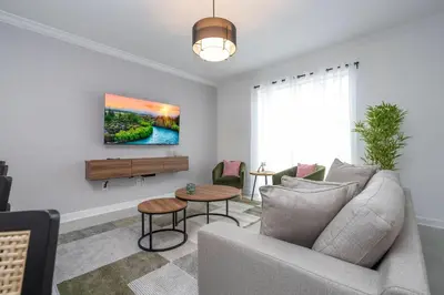 a living room with a couch and a table at Brand New Cozy Retreat at Storey Lake Resort in Kissimmee