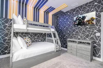 a kids room with a bunk bed and a bedroom with a wall at Stunning 5 Bd w Pool at Storey Lake Resort 2400 in Kissimmee