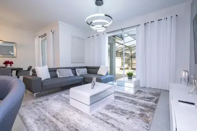 a living room with a couch and a table at Stunning 4 Bd w Pool @ Storey Lake Resort 2613 in Kissimmee
