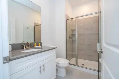 a bathroom with a toilet and a shower at Stunning 4 Bd w Pool @ Storey Lake Resort 2613 in Kissimmee