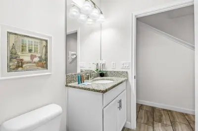 a white bathroom with a sink and a mirror at Home with a pool at Storey Lake Resort in Kissimmee