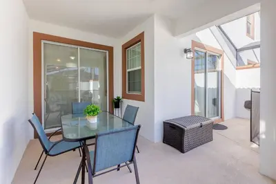a dining room with a glass table and chairs at Family 4BR w Private Pool near Disney Parks in Kissimmee