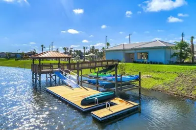 a group of inflatables on a dock in the water at Makin Memories Gated Resort Style Community Storey Lake in Kissimmee