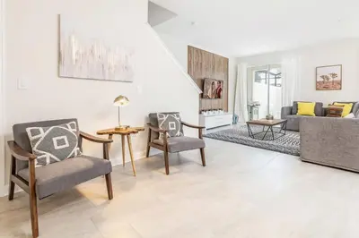 a living room with two chairs and a couch at Disney Dream Home Prime Location Private Pool in Kissimmee