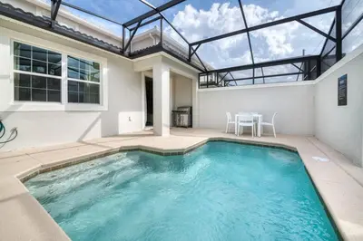 a swimming pool in a house with a glass ceiling at Disney Dream Home Prime Location Private Pool in Kissimmee