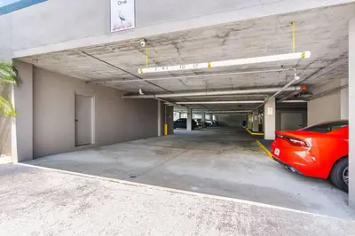 a parking garage with a red car parked in it at Lakeview newly renovated condo near Disney in Orlando