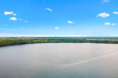 a large body of water with trees and a beach at Lakeview newly renovated condo near Disney in Orlando