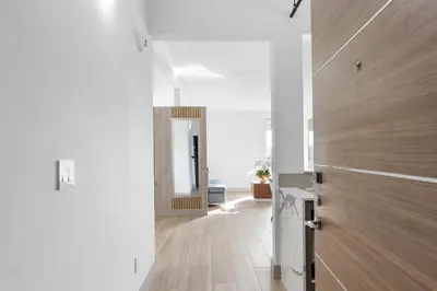 a hallway with a wooden door in a room at Kompose Boutique Resort @ Theme Parks in Kissimmee