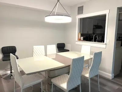 a dining room with a white table and chairs at House close Baldwin-park Lake & Downtown Orlando in Orlando