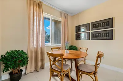 a dining room with a table and chairs and a window at 4 BR Home w/ Resort Amenities + 3 Mi to Disney in Orlando