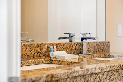a bathroom counter with two sinks and a mirror at 4 BR Home w/ Resort Amenities + 3 Mi to Disney in Orlando