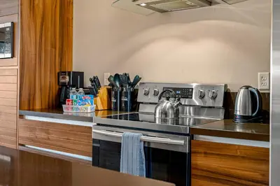 a kitchen with a stainless steel stove top oven at Outdoor Kitchen + 8 Min to Disney + Resort Cabanas in Orlando