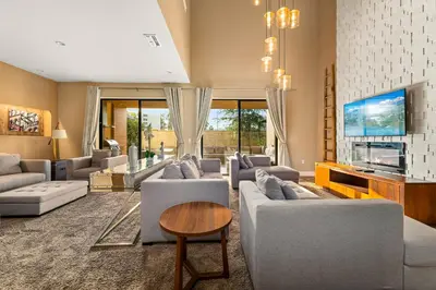 a living room with couches and a flat screen tv at Outdoor Kitchen + 8 Min to Disney + Resort Cabanas in Orlando