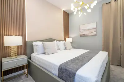 a bedroom with a large bed and a lamp at 6163 Fantastic Home with 12BD in Orlando