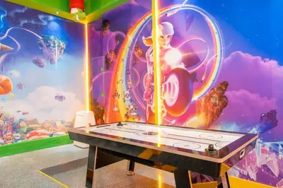 a ping pong table in a room with a mural at 6163 Fantastic Home with 12BD in Orlando