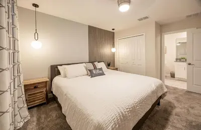 a bedroom with a large white bed and a door at Incredible 6BR Villa by Disney Private Pool Games in Kissimmee