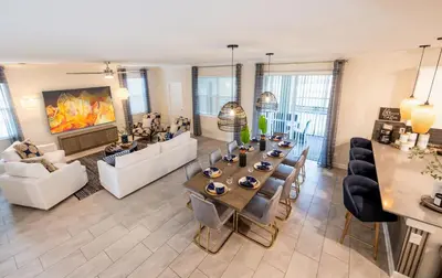 a large living room with a table and chairs at Incredible 6BR Villa by Disney Private Pool Games in Kissimmee