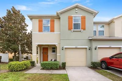 a house with a red car parked in front of it at Amazing 4BdrmsPrivate Hot Tub7 miles from Disney in Kissimmee