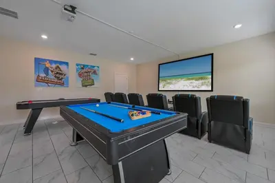 a game room with a pool table and a flat screen tv at Charming Home Ideal Location Spacious Game Room in Kissimmee