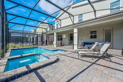 a house with a swimming pool and a patio at Disney Bliss Themed Rooms Game Room Private Pool in Kissimmee