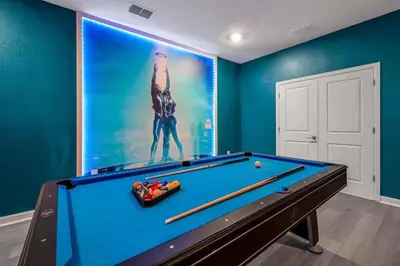 a pool table in a room with a large mural at Disney Bliss Themed Rooms Game Room Private Pool in Kissimmee