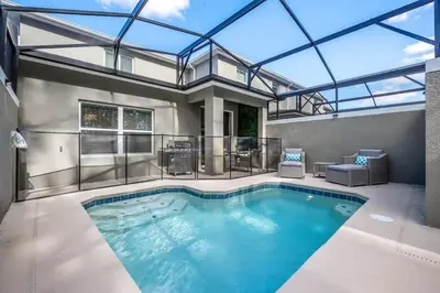 a large swimming pool with a glass roof at Luxury Chic Modern Home Prime Location in Kissimmee