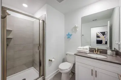 a bathroom with a shower and a toilet and a sink at Luxury Chic Modern Home Prime Location in Kissimmee
