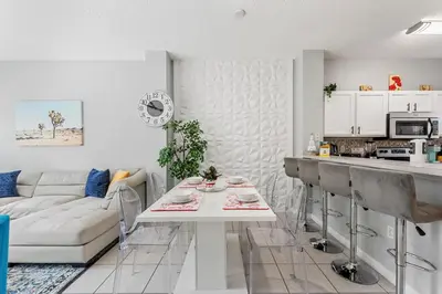 a kitchen and living room with a table and a couch at Serene Stay at Terra Verde Resort by Shine Villas 111 townhouse in Kissimmee