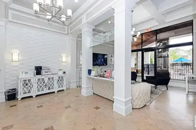 a large white room with a bed and a table at Orlando Retreat 2B2B / Disney-Universal-SeaWorld in Orlando
