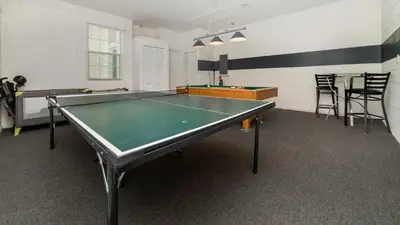 a room with a ping pong table in it at 8150 Fan Palm in Kissimmee