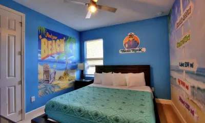 a bedroom with a bed with blue walls and posters at All Vacation Large Pool Home w-Cinema-Bowling Alley-Sleep 40 in Kissimmee
