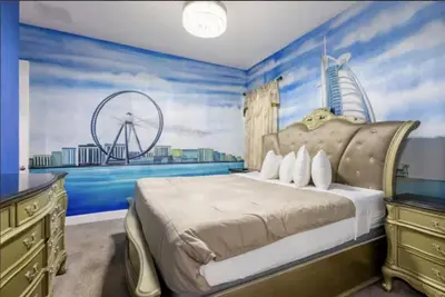 a bedroom with a large bed with blue walls at Enchanting a Magical Orlando Trip in Kissimmee