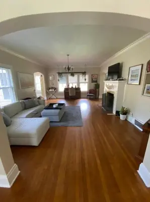 a living room with a white couch and a fireplace at Beautiful Private Room With King Size Bed in Downtown Orlando in Orlando