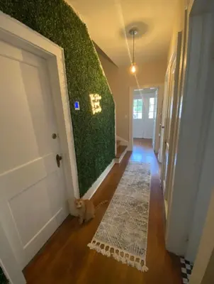 a hallway with a green wall in a house at Beautiful Private Room With King Size Bed in Downtown Orlando in Orlando
