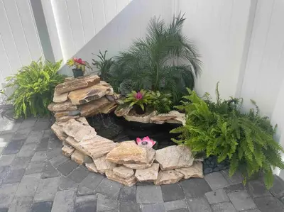 a rock garden with flowers and plants in it at The Tiny Cottage in the Springs/ Central FL in Altamonte Springs