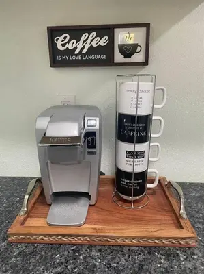 a coffee machine on a wooden tray with a coffee mug at The Tiny Cottage in the Springs/ Central FL in Altamonte Springs