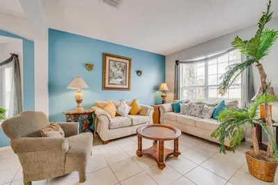 a living room with two couches and a table at 7 Mi to Disney Kissimmee Home with Pool and Hot Tub! in Kissimmee