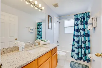 a bathroom with a sink and a toilet and a shower at 7 Mi to Disney Kissimmee Home with Pool and Hot Tub! in Kissimmee