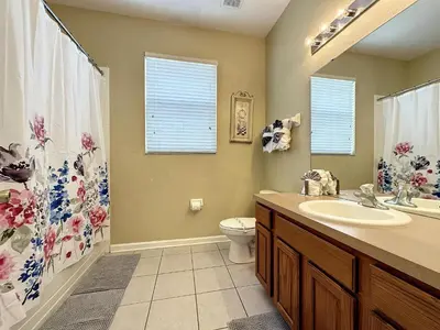 a bathroom with a sink and a toilet and a shower at This amazing 6 Bedroom property with a lake view in Orlando