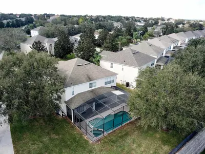 an aerial view of a house with a swimming pool at This amazing 6 Bedroom property with a lake view in Orlando