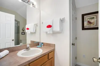 a bathroom with a sink and a mirror at Tropical and peaceful, this 5 bed with Pool & Spa in Orlando