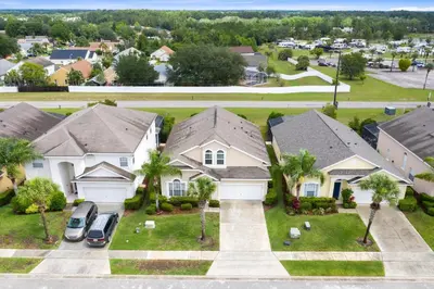 an aerial view of a house with palm trees at Tropical and peaceful, this 5 bed with Pool & Spa in Orlando