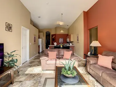 a living room with two couches and a table at Emerald Island Resort 4 bed 3 bath with pool/spa in Kissimmee